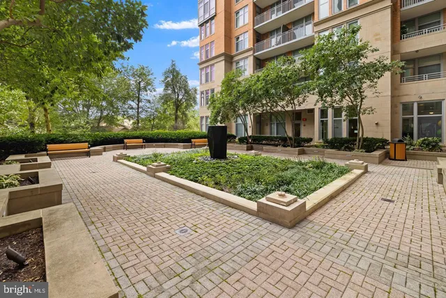 a living room with furniture a fireplace and a chandelier