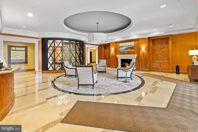 a dining room with furniture and a large window