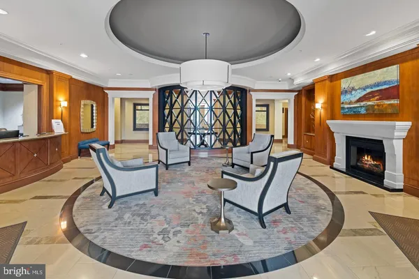 a living room with furniture a chandelier and a large window