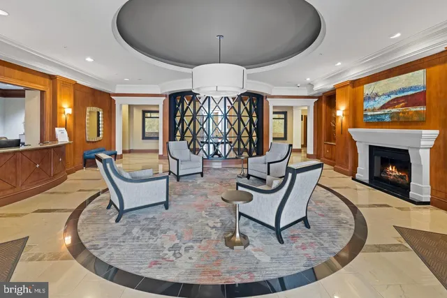 a living room with furniture a chandelier and a large window