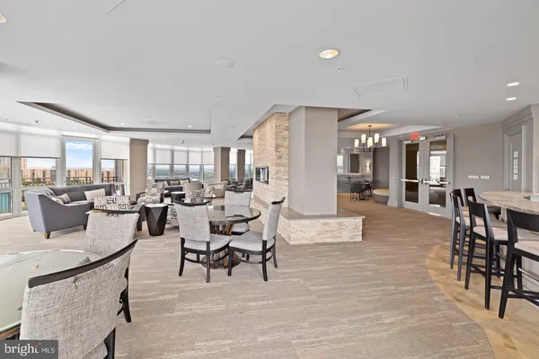 a kitchen with a dining table chairs and refrigerator