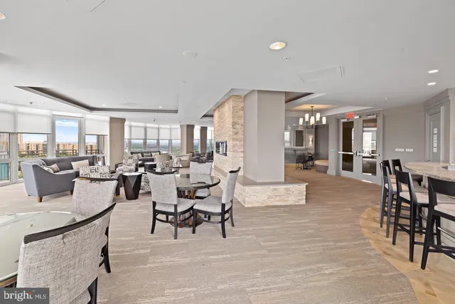 a kitchen with a dining table chairs and refrigerator