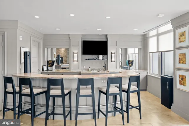 a view of a swimming pool with outdoor seating