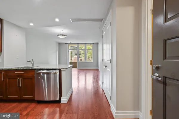 a view of a kitchen with wooden floor and a sink