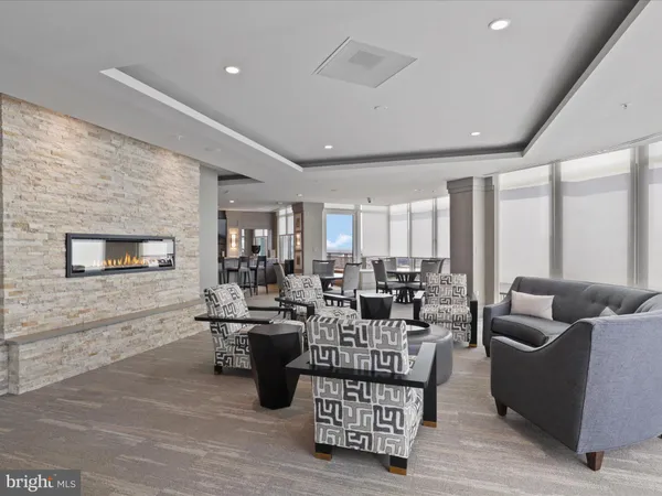 a kitchen with a dining table chairs and flat screen tv