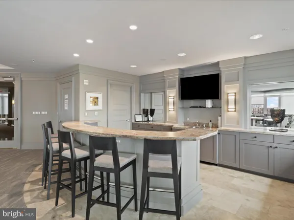 a living room with furniture a large window and kitchen view
