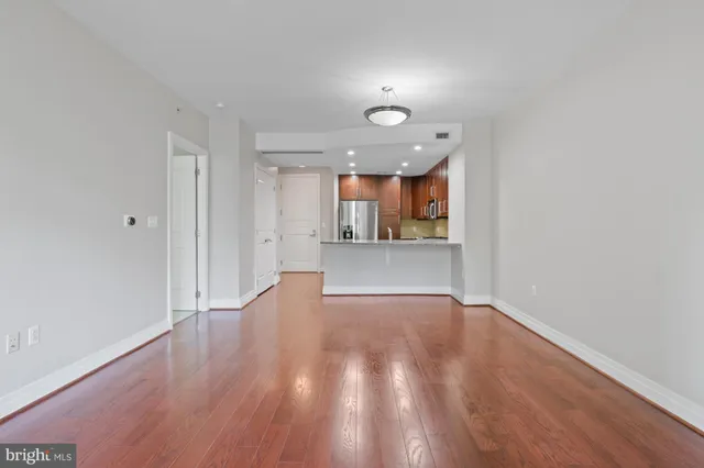 a view of a kitchen with a sink and a refrigerator