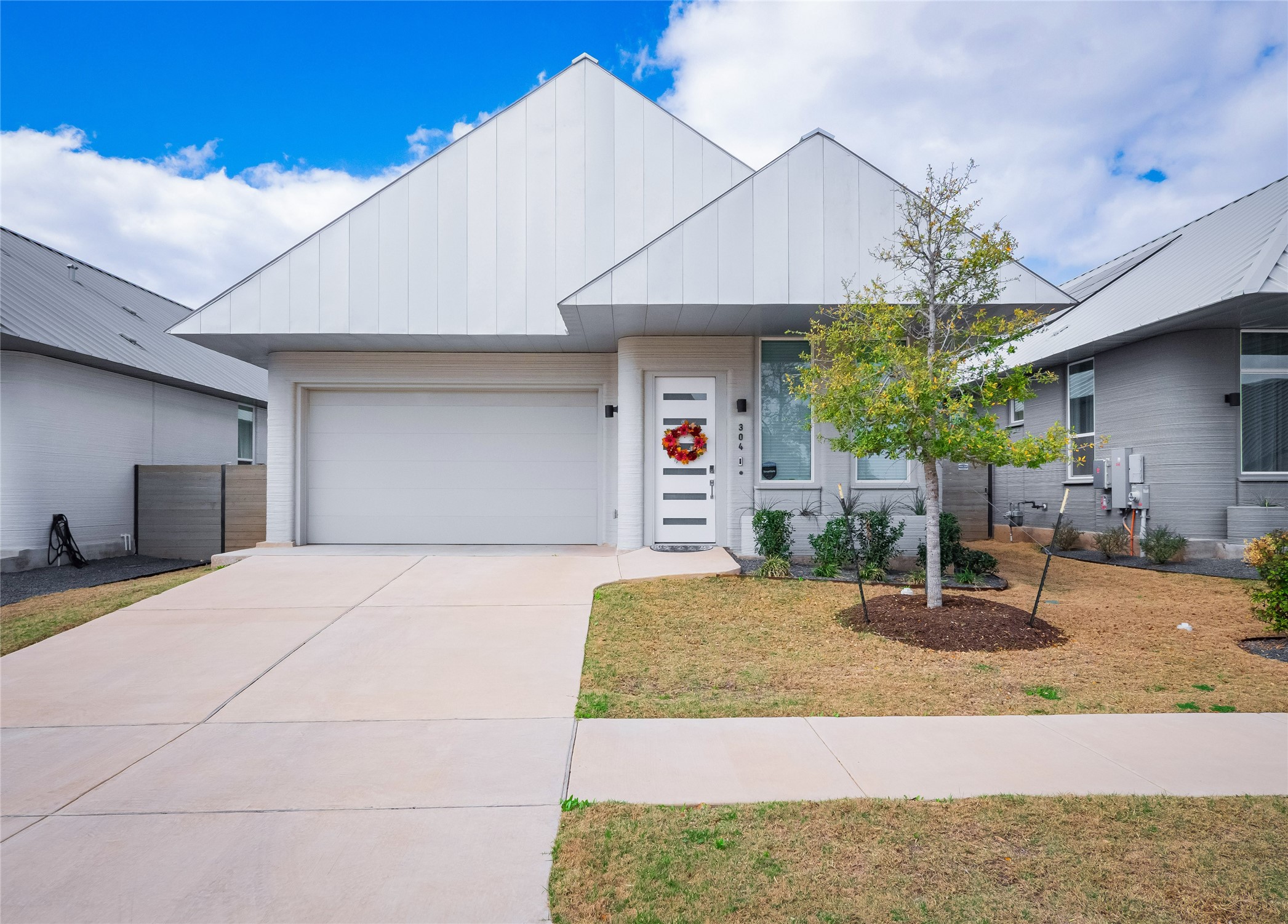 a bedroom with a bed a chandelier and potted plant on the table