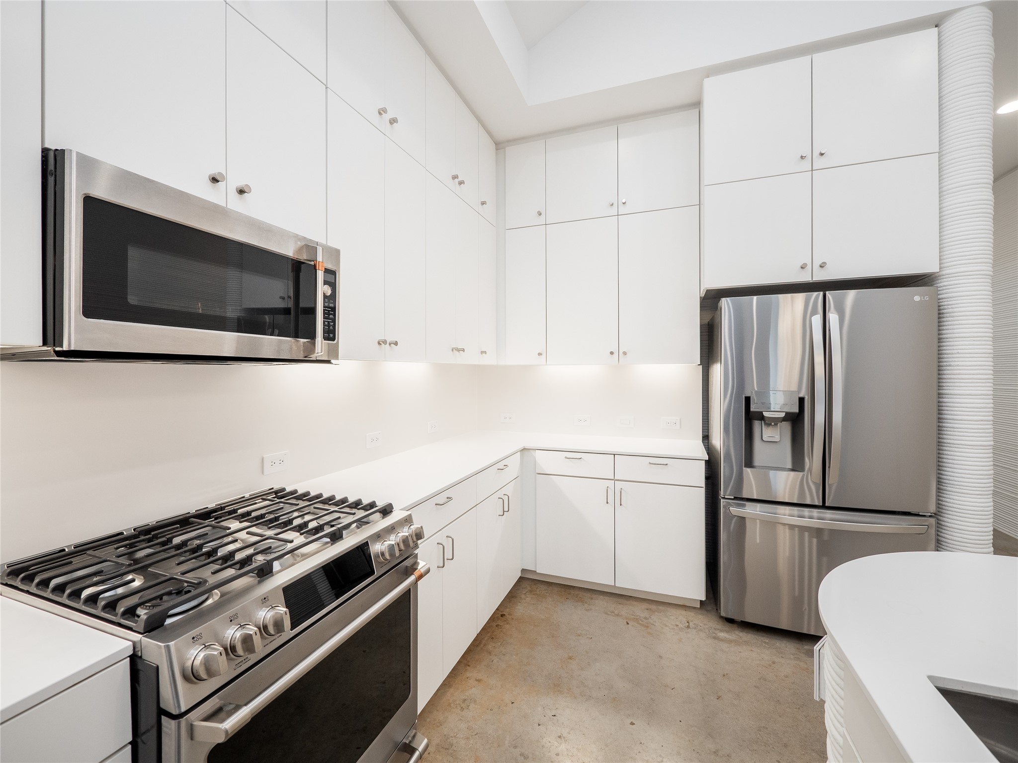 304 Painted Sunset Drive Georgetown, TX 78628 - Photo 12 of 38 a kitchen with white cabinets and stainless steel appliances