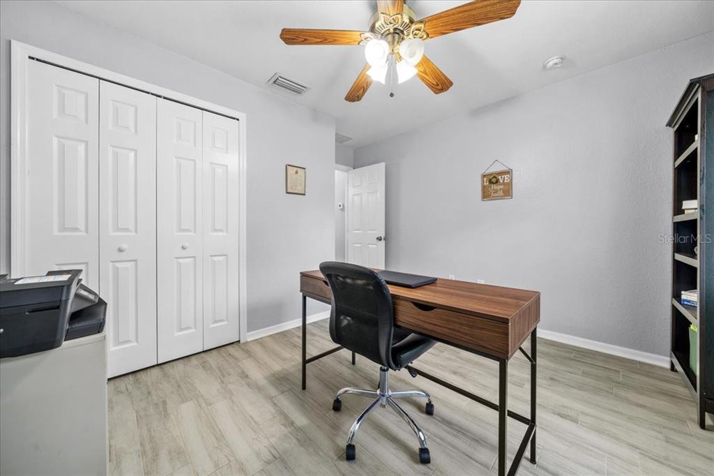 8890 Southwest 33rd Court Ocala, FL 34476 - Photo 23 of 58 a view of a workspace with furniture and wooden floor