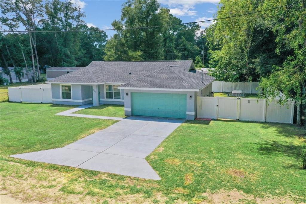 8890 Southwest 33rd Court Ocala, FL 34476 - Photo 33 of 58 a aerial view of a house with a yard and a garage