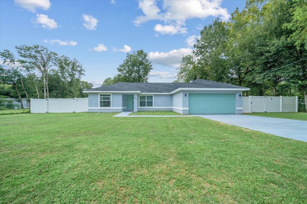 8890 Southwest 33rd Court Ocala, FL 34476 - Photo 42 of 58 a front view of house with a garden