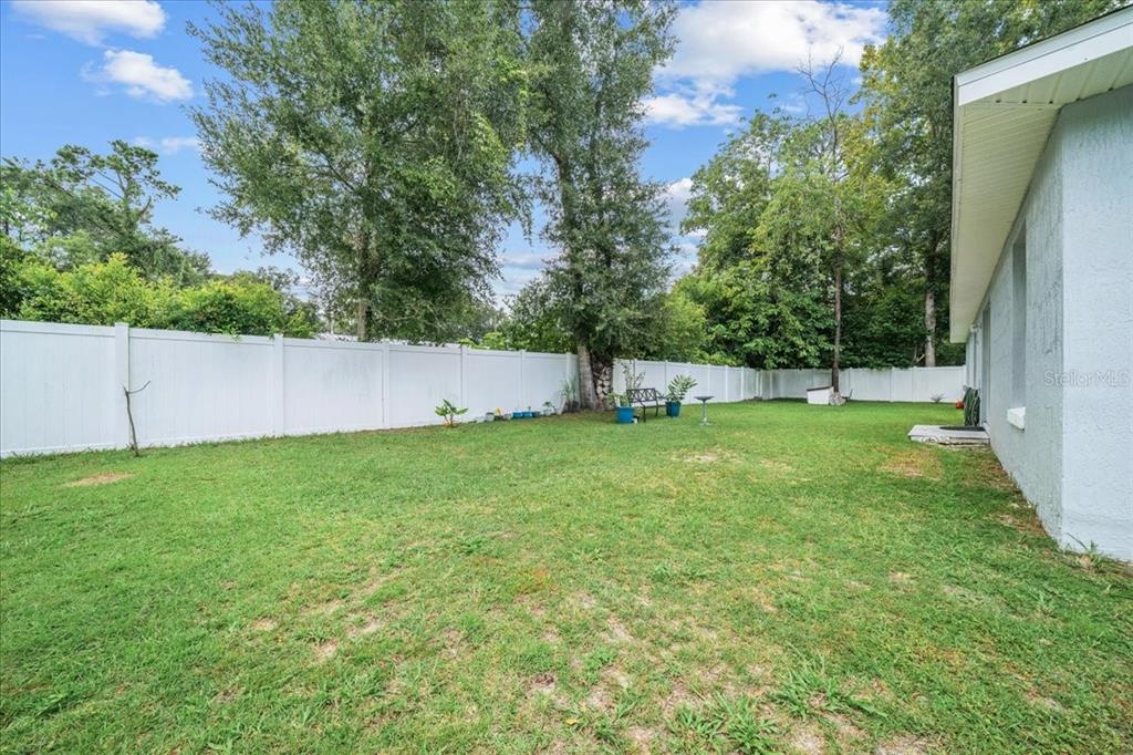 8890 Southwest 33rd Court Ocala, FL 34476 - Photo 48 of 58 a view of yard with grass and trees