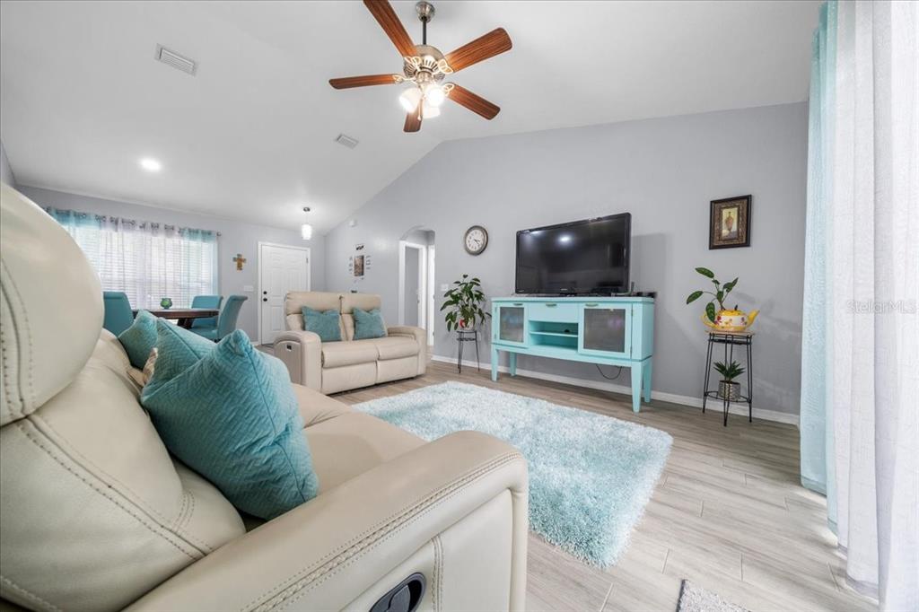 8890 Southwest 33rd Court Ocala, FL 34476 - Photo 8 of 58 a living room with furniture and a flat screen tv