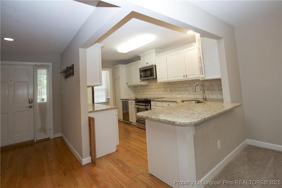 175 Knoll Road Southern Pines, NC 28387 - Photo 5 of 50 a kitchen with stainless steel appliances granite countertop a sink stove and refrigerator