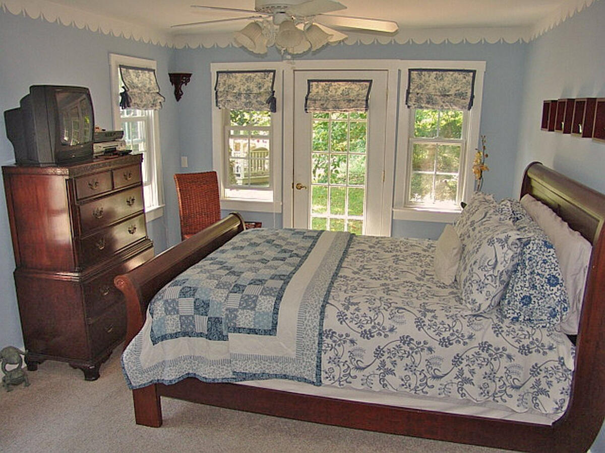 492 Greenhouse Road Lexington, VA 24450 - Photo 14 of 27 a bedroom with a bed and wooden floor