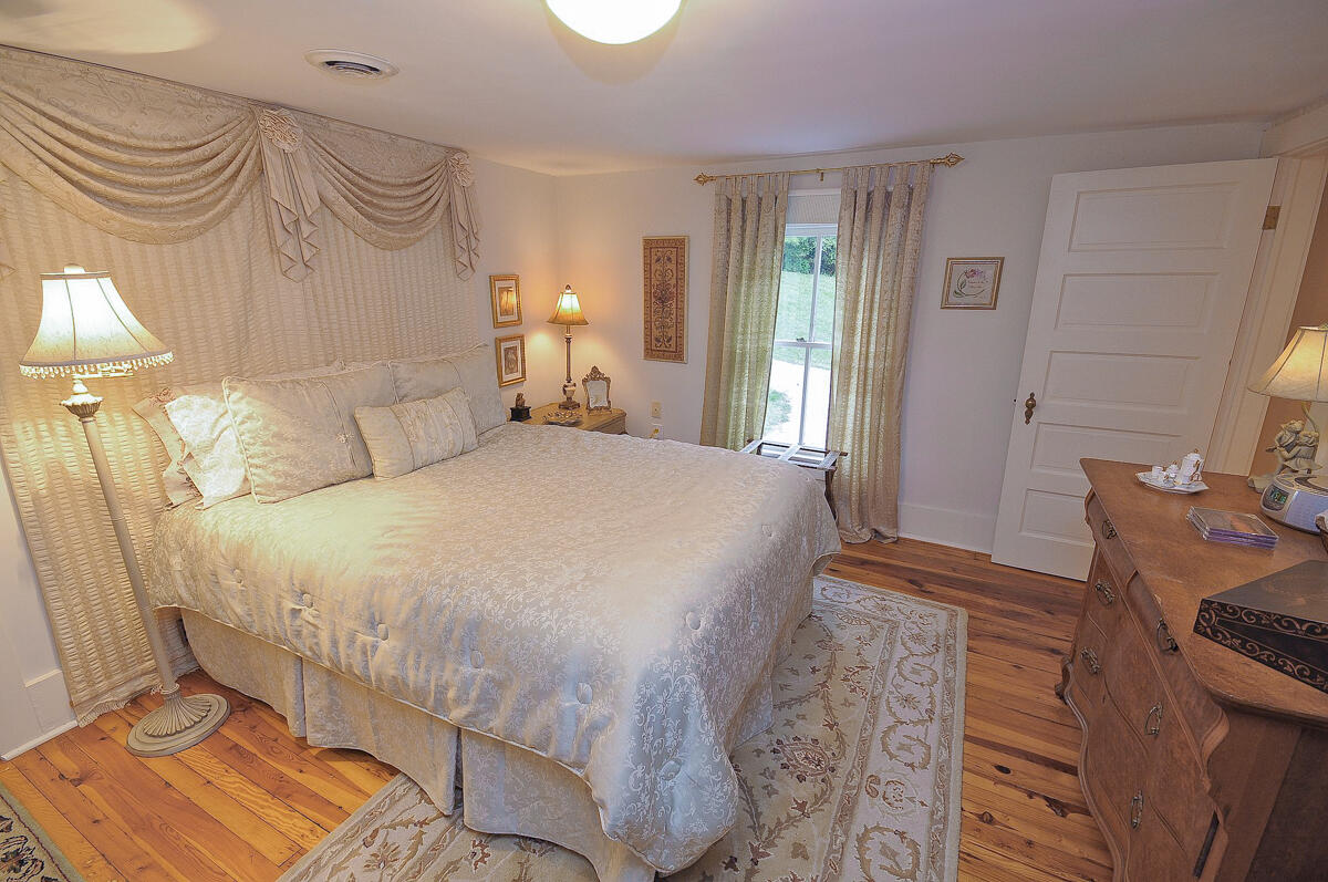 492 Greenhouse Road Lexington, VA 24450 - Photo 21 of 27 a bedroom with a bed and a lamp with the dresser
