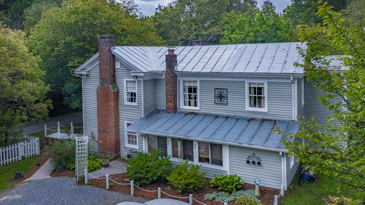 492 Greenhouse Road Lexington, VA 24450 - Photo 4 of 27 a view of a house with brick walls and a large tree
