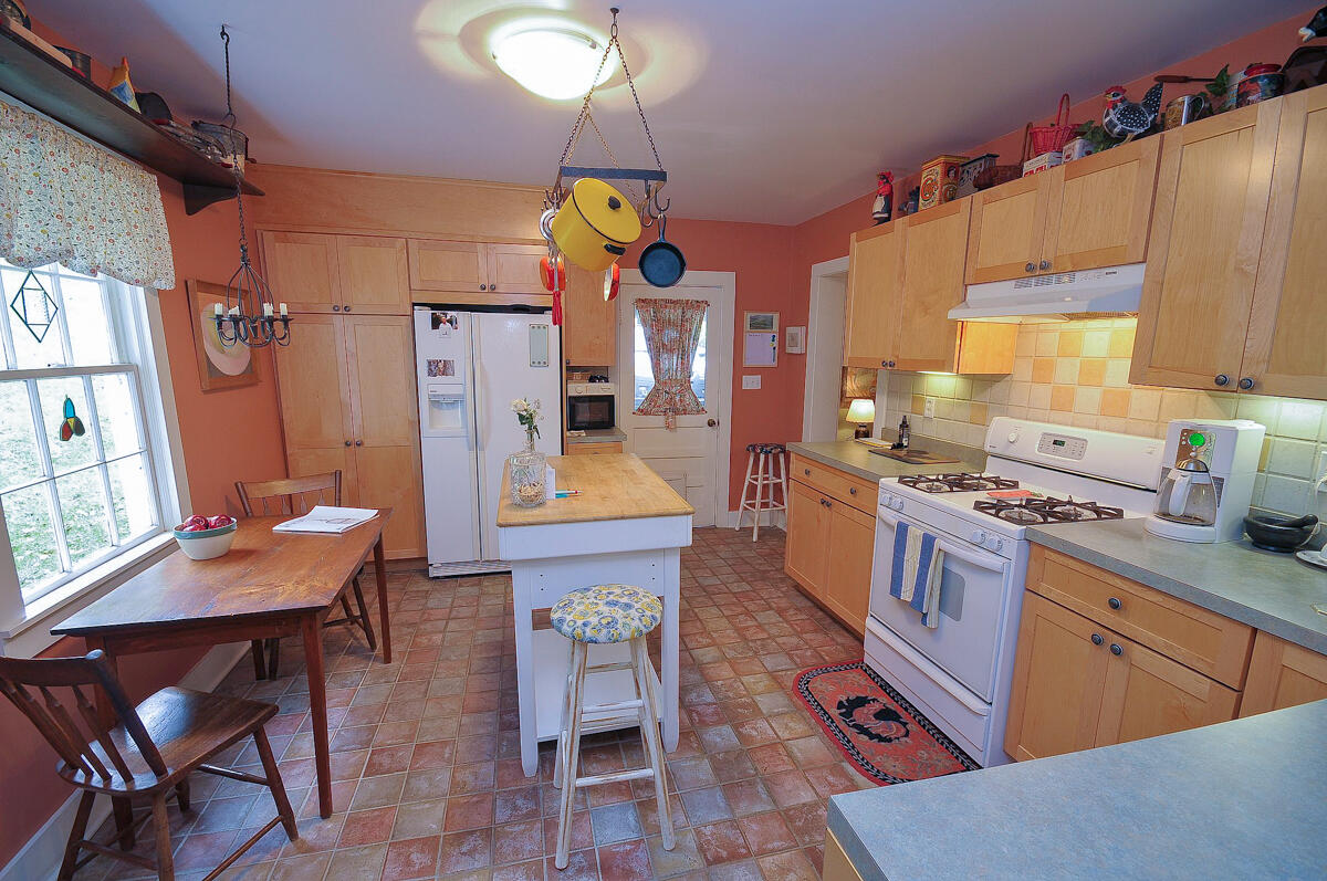 492 Greenhouse Road Lexington, VA 24450 - Photo 10 of 27 a kitchen with stainless steel appliances kitchen island granite countertop a table chairs in it and a wooden floor