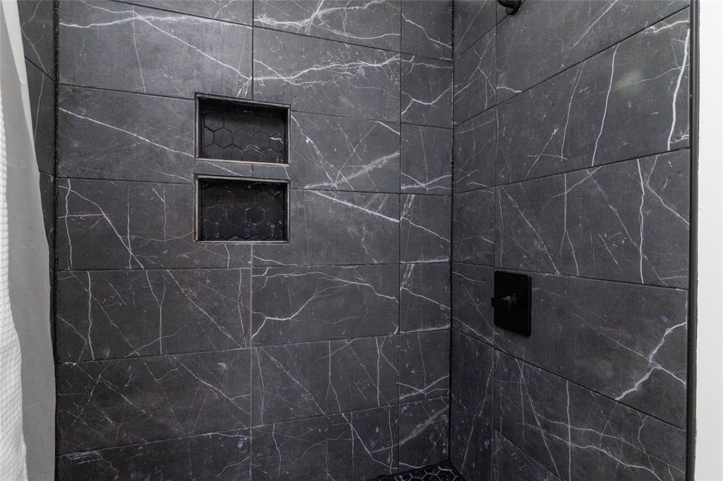 1908 Monte Cristo Drive Sherman, TX 75092 - Photo 23 of 38 a bathroom with a shower and a tiled wall