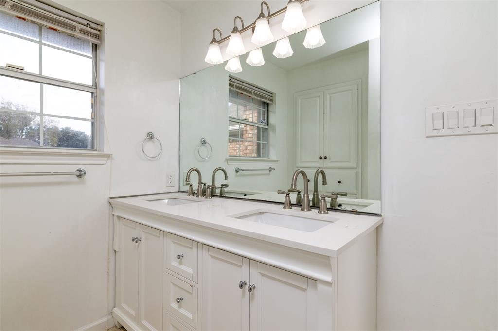 1908 Monte Cristo Drive Sherman, TX 75092 - Photo 28 of 38 a bathroom with a sink a vanity and a mirror