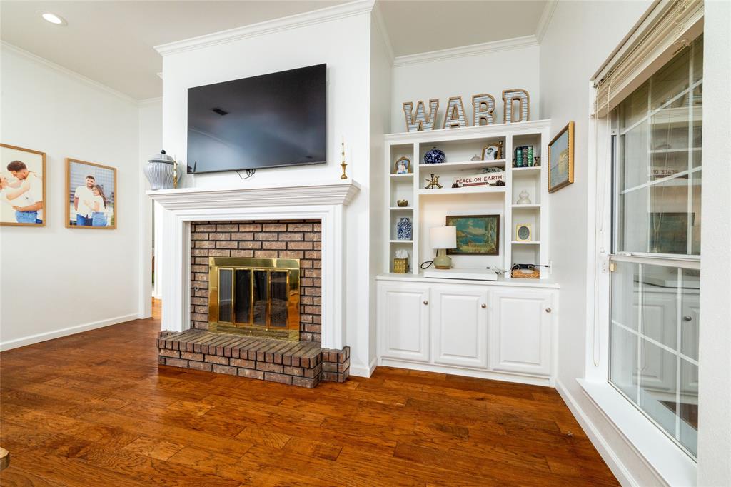 1908 Monte Cristo Drive Sherman, TX 75092 - Photo 5 of 38 a view of an empty room with windows fireplace and wooden floor
