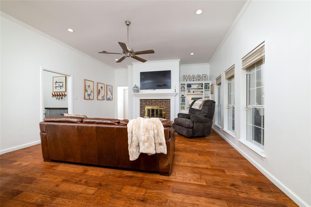 1908 Monte Cristo Drive Sherman, TX 75092 - Photo 8 of 38 a living room with furniture a fireplace and a flat screen tv