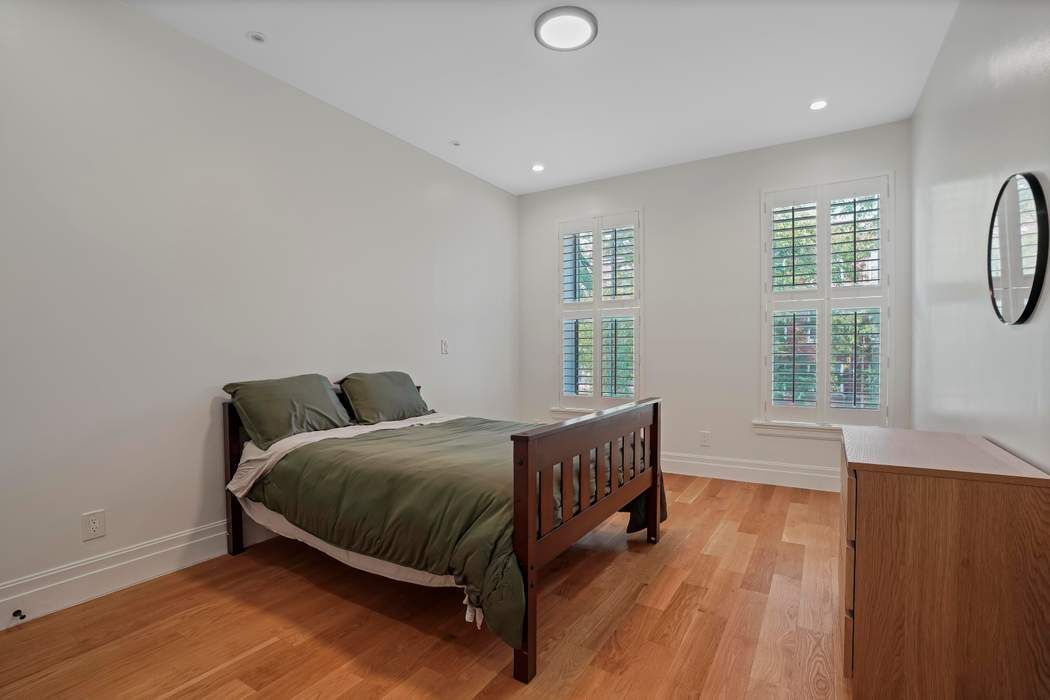 682 Madison Street Brooklyn, NY 11221 - Photo 13 of 28 a bed room with a bed and a window