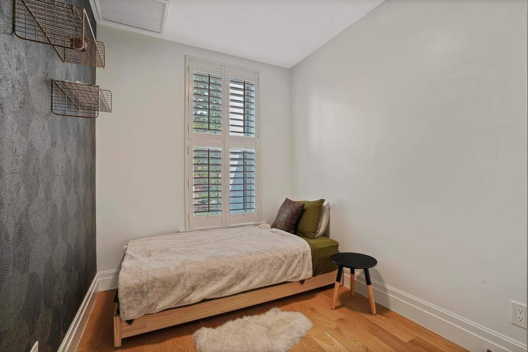 682 Madison Street Brooklyn, NY 11221 - Photo 14 of 28 a bedroom with a bed and a window