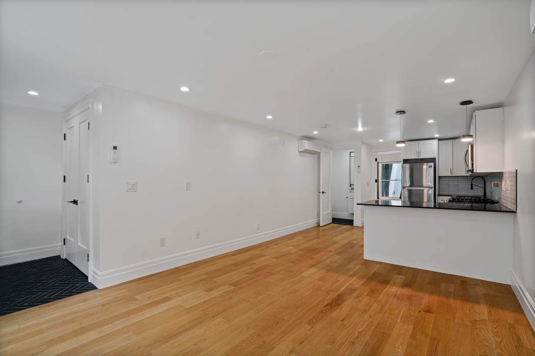 682 Madison Street Brooklyn, NY 11221 - Photo 18 of 28 a view of kitchen with wooden floor