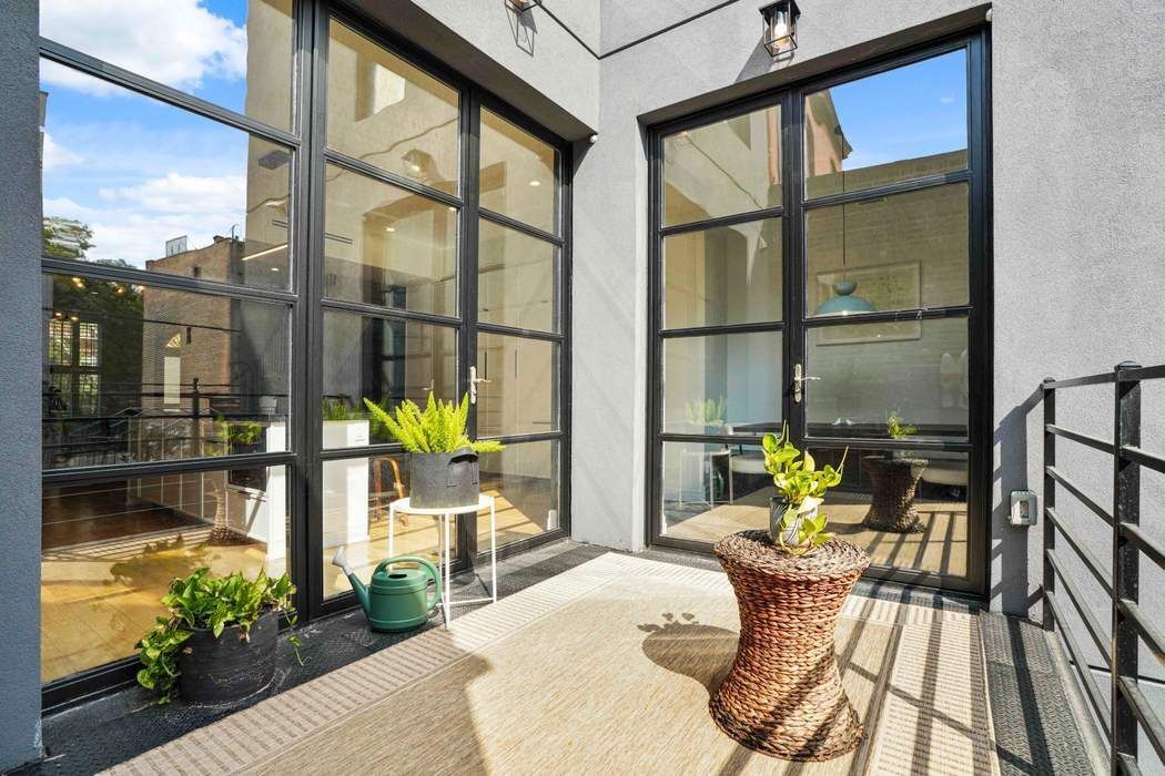 682 Madison Street Brooklyn, NY 11221 - Photo 21 of 28 a view of balcony with two chairs and a potted plant