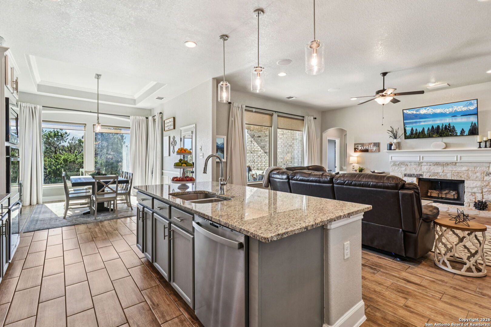 1074 Boulder New Braunfels, TX 78132 - Photo 15 of 40 a large kitchen with kitchen island a large counter space a sink appliances and living room view