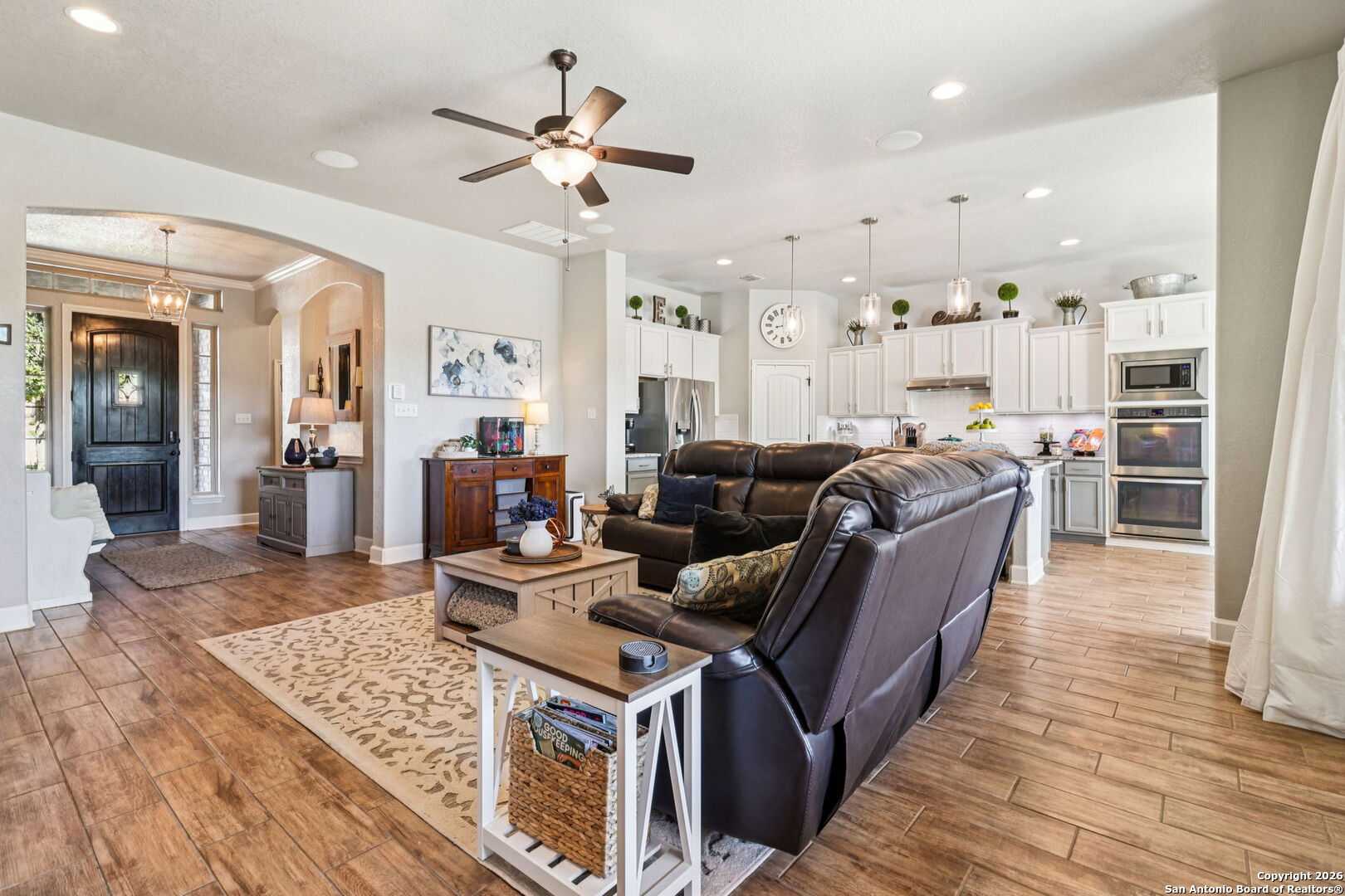 1074 Boulder New Braunfels, TX 78132 - Photo 7 of 40 a living room with furniture a large window and wooden floor