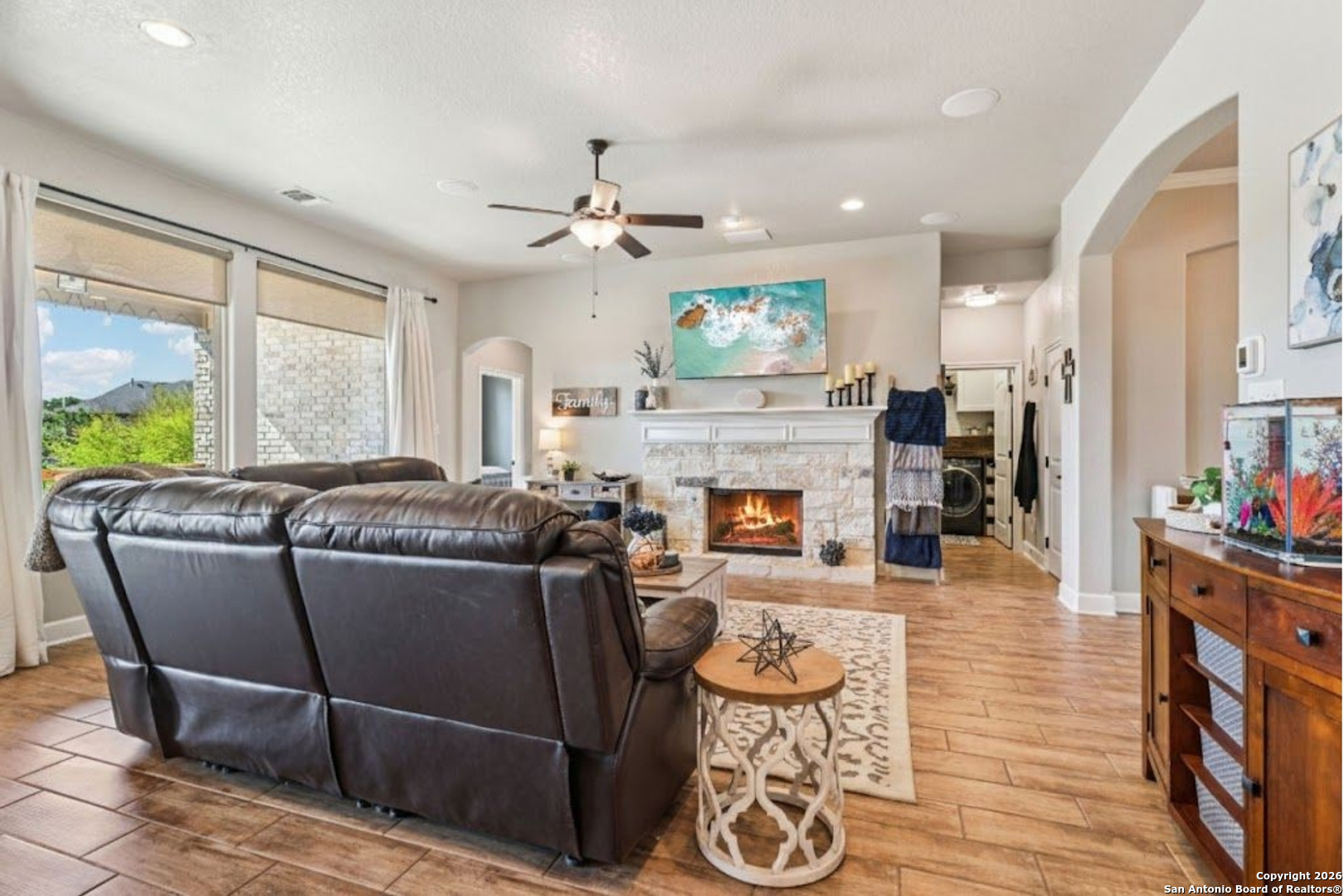 1074 Boulder New Braunfels, TX 78132 - Photo 8 of 40 a living room with furniture a fireplace and a floor to ceiling window