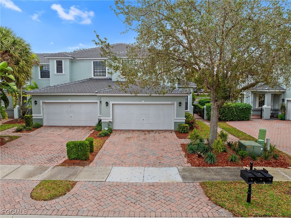 14764 Pinnacle Place, Unit 65 Naples, FL 34119 - Photo 1 of 50 a front view of a house with garden