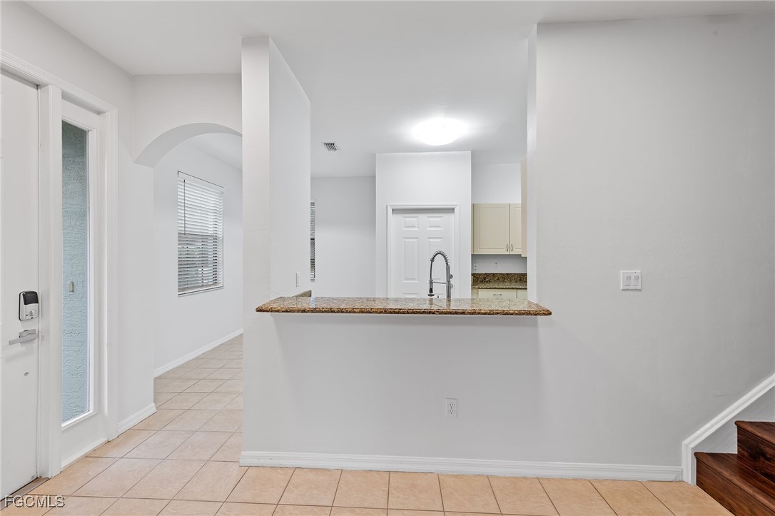 14764 Pinnacle Place, Unit 65 Naples, FL 34119 - Photo 13 of 50 a view of a kitchen with sink and refrigerator