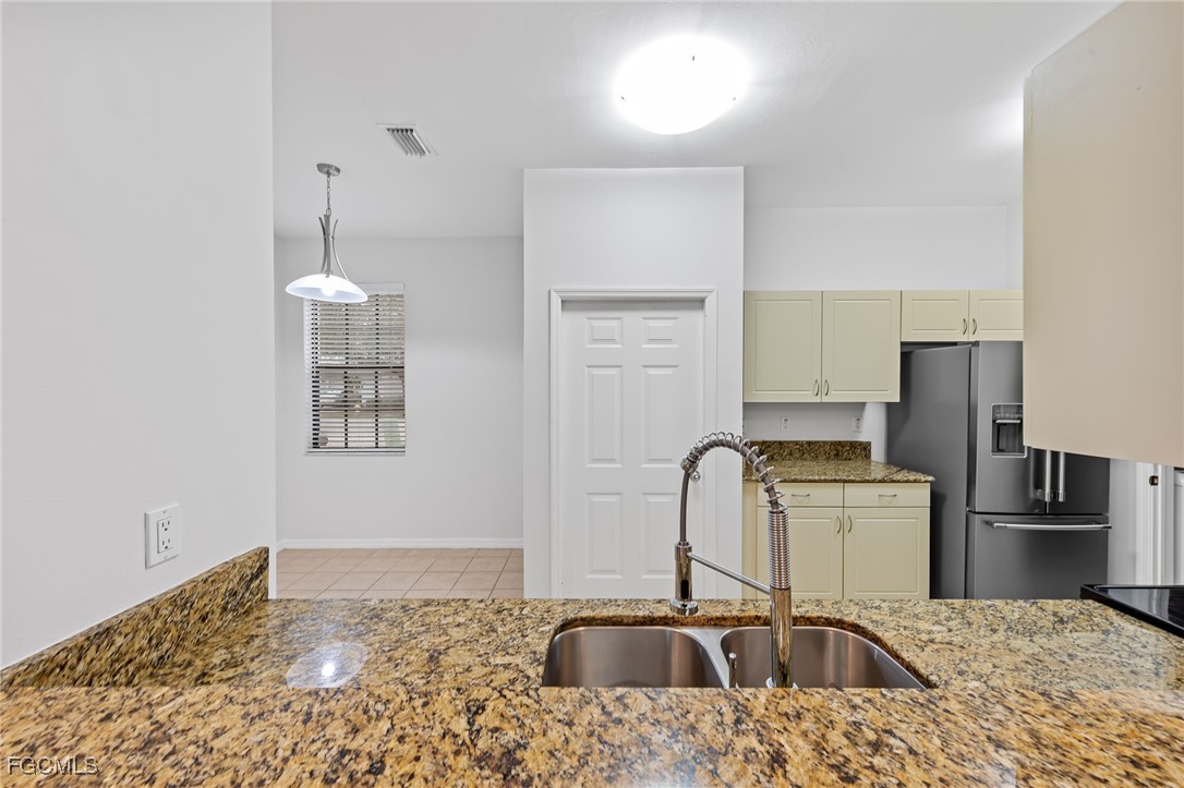 14764 Pinnacle Place, Unit 65 Naples, FL 34119 - Photo 14 of 50 a bathroom with a sink a window and a refrigerator