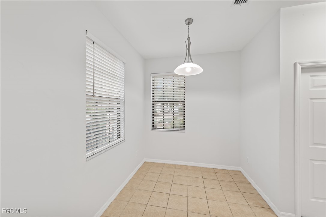 14764 Pinnacle Place, Unit 65 Naples, FL 34119 - Photo 15 of 50 a view of an empty room with a window