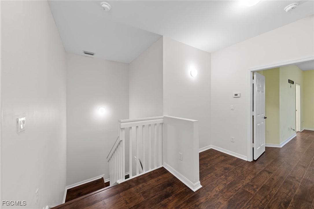 14764 Pinnacle Place, Unit 65 Naples, FL 34119 - Photo 21 of 50 a view of an empty room with wooden floor