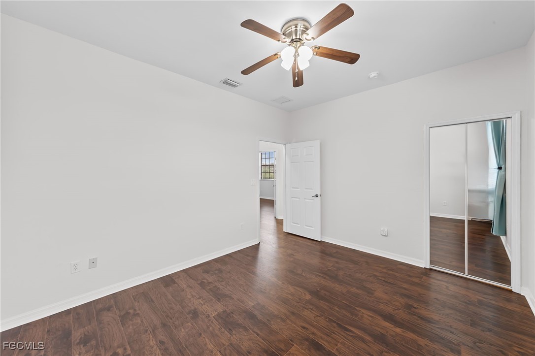 14764 Pinnacle Place, Unit 65 Naples, FL 34119 - Photo 23 of 50 an empty room with wooden floor and ceiling fan