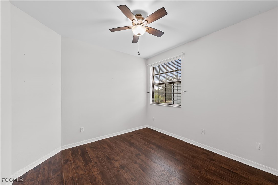 14764 Pinnacle Place, Unit 65 Naples, FL 34119 - Photo 25 of 50 an empty room with a window and a ceiling fan