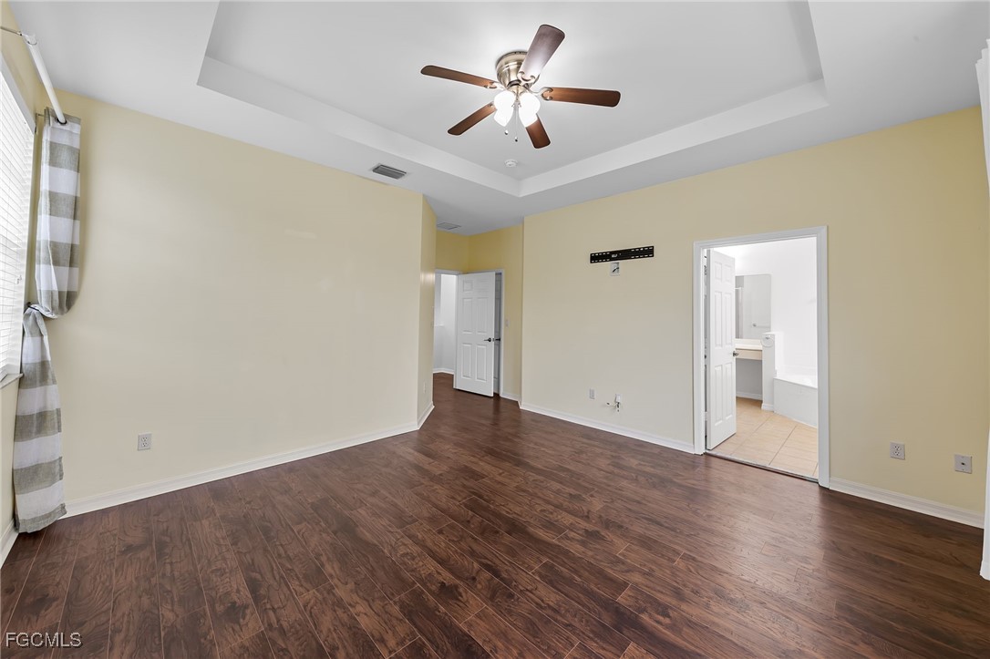 14764 Pinnacle Place, Unit 65 Naples, FL 34119 - Photo 28 of 50 wooden floor in an empty room with a window