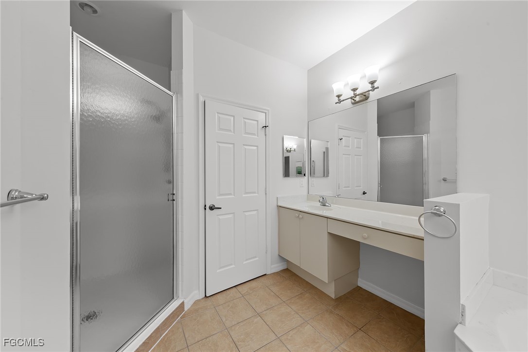 14764 Pinnacle Place, Unit 65 Naples, FL 34119 - Photo 31 of 50 a bathroom with a double vanity sink mirror and shower