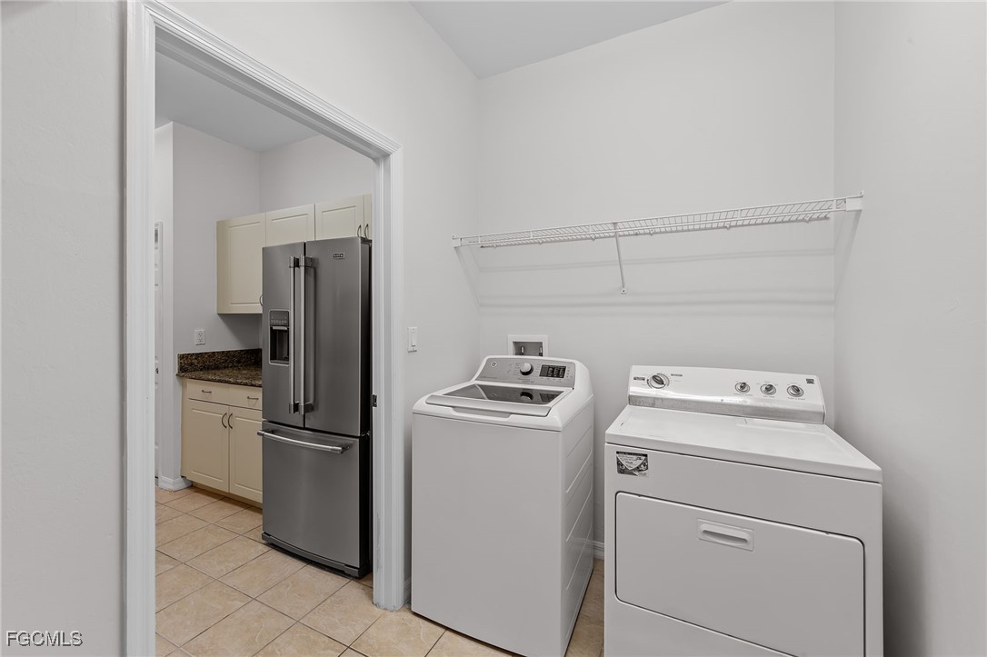 14764 Pinnacle Place, Unit 65 Naples, FL 34119 - Photo 39 of 50 a utility room with dryer and washer