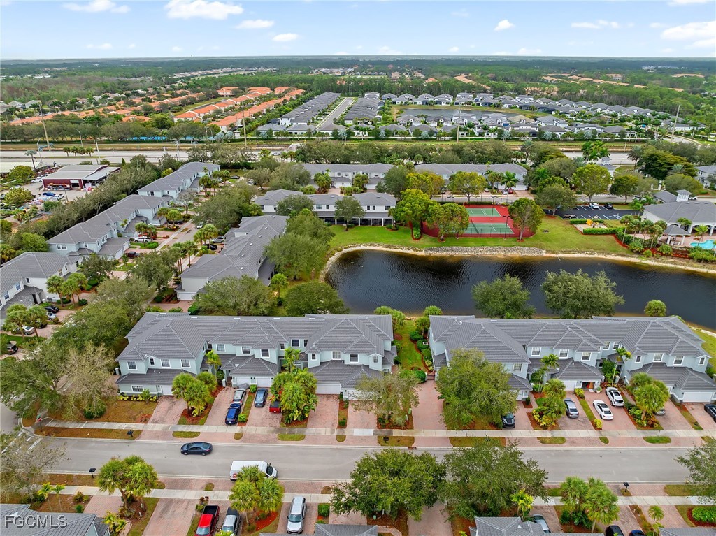 14764 Pinnacle Place, Unit 65 Naples, FL 34119 - Photo 49 of 50 an aerial view of residential building and lake