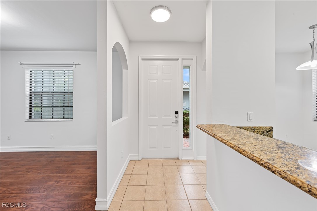 14764 Pinnacle Place, Unit 65 Naples, FL 34119 - Photo 5 of 50 a bathroom with a granite countertop sink and a mirror