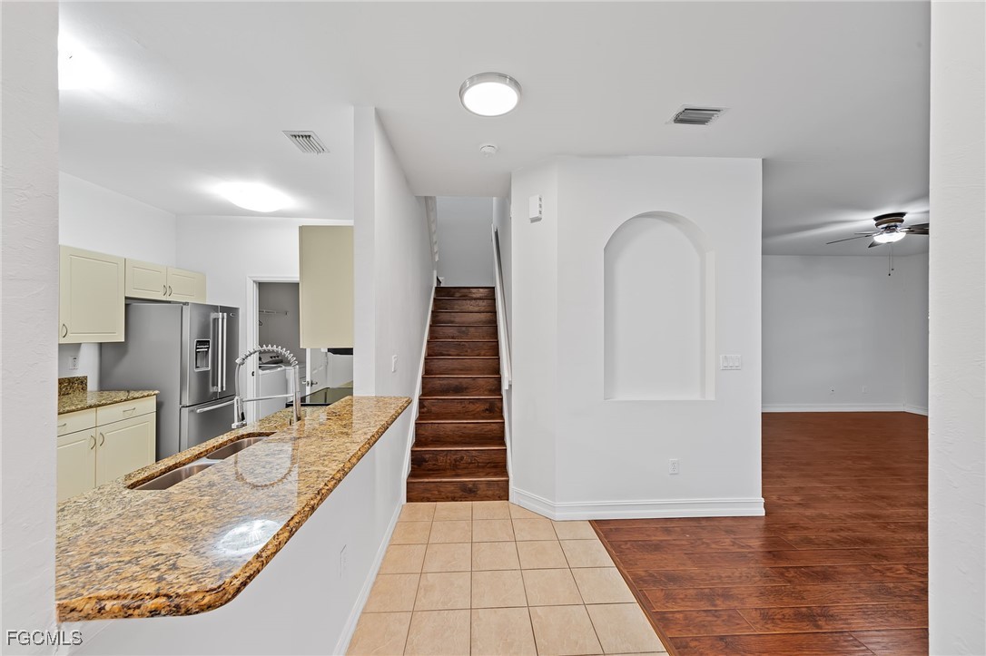 14764 Pinnacle Place, Unit 65 Naples, FL 34119 - Photo 6 of 50 an entryway with wooden floor and a living room