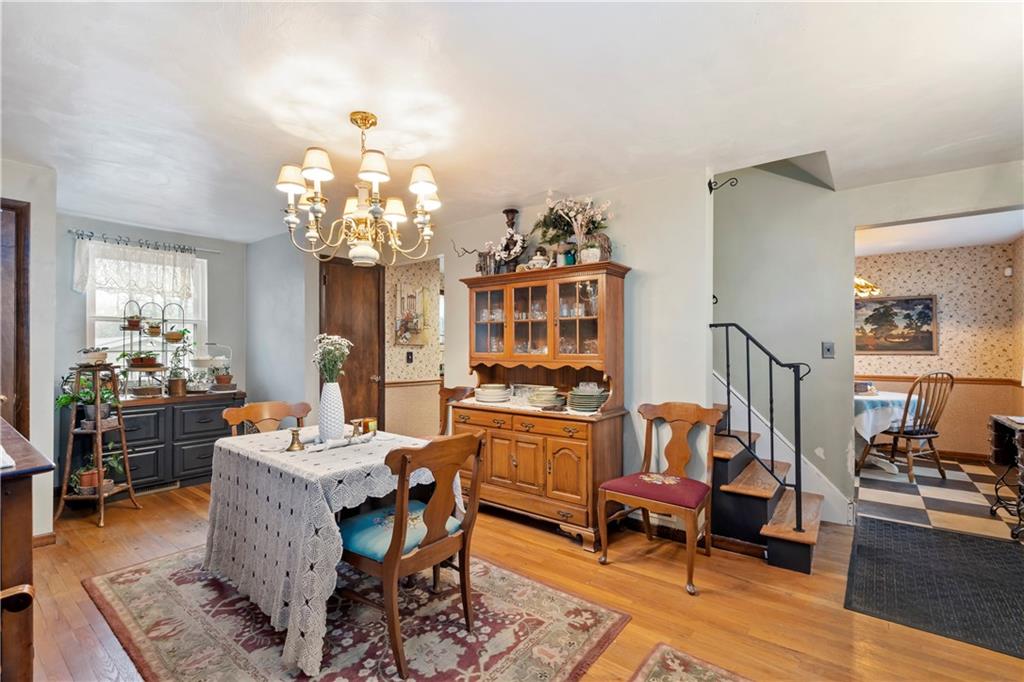 8263 Peebles Road Pittsburgh, PA 15237 - Photo 9 of 49 a living room with fireplace furniture and a chandelier