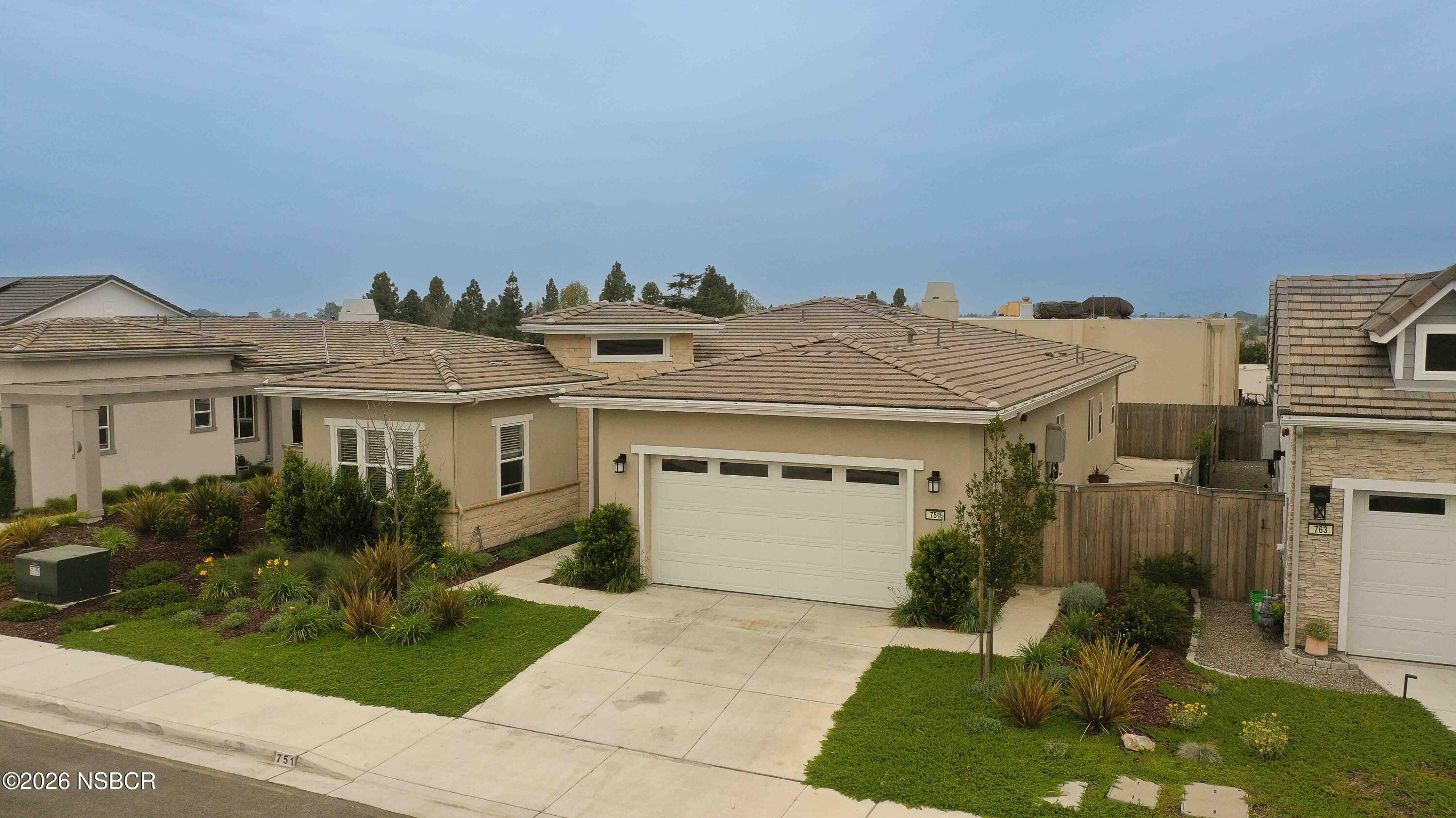 751 Skyview Lane Santa Maria, CA 93455 - Photo 1 of 27 a view of a white house with a yard and potted plants