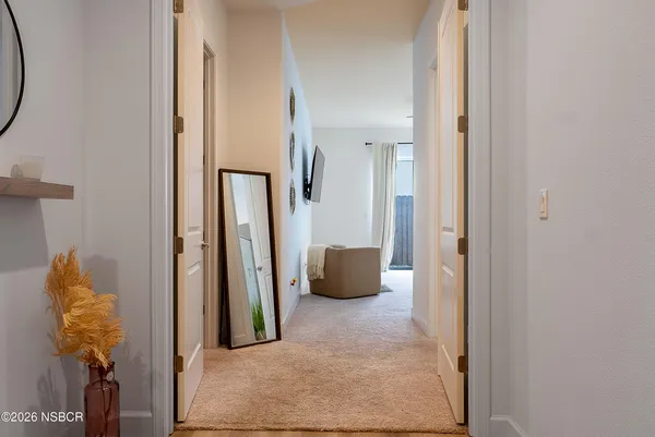 a large bed sitting in a bedroom next to a window